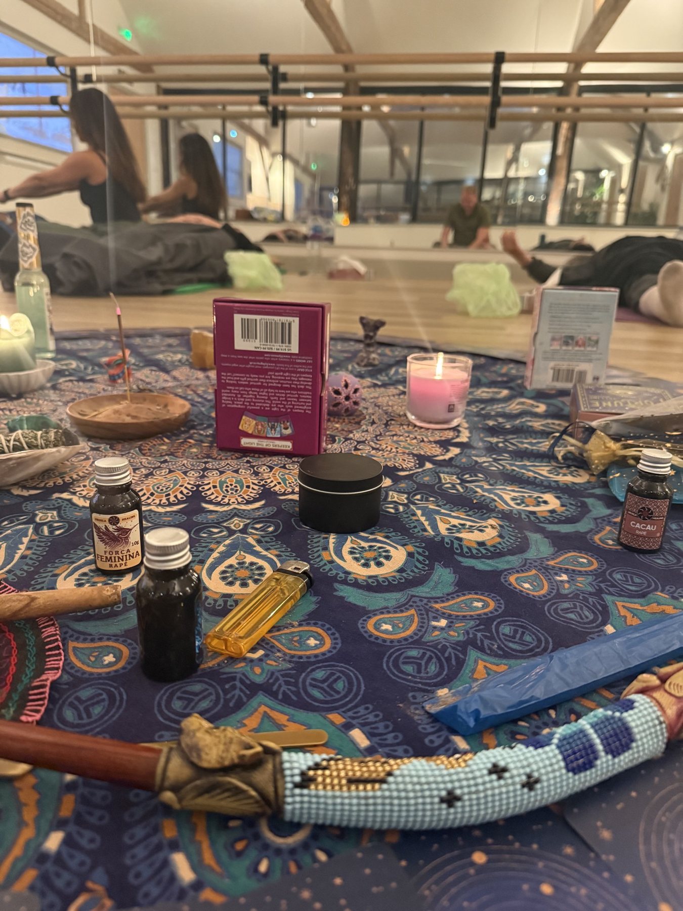 The altar at Soul Barns after ceremony: hapé, cacao, candlelight and the tepi on a patterned cloth, the circle resting beyond.